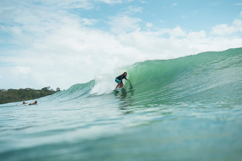 a surfer gets a barrel at paunch reef in bocas del toro panama.